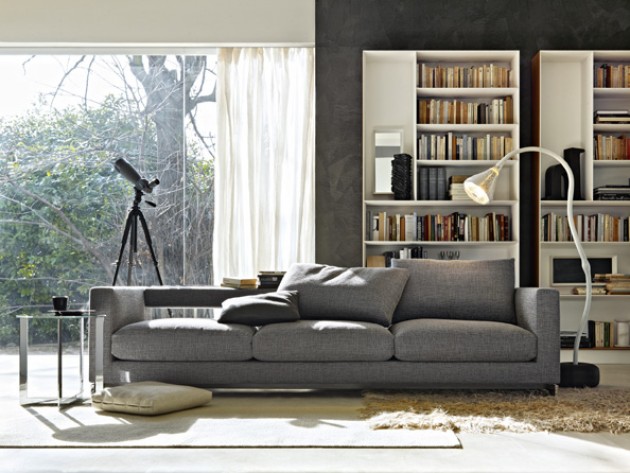 Salon moderne avec bibliothèque blanc laqué et canapé gris